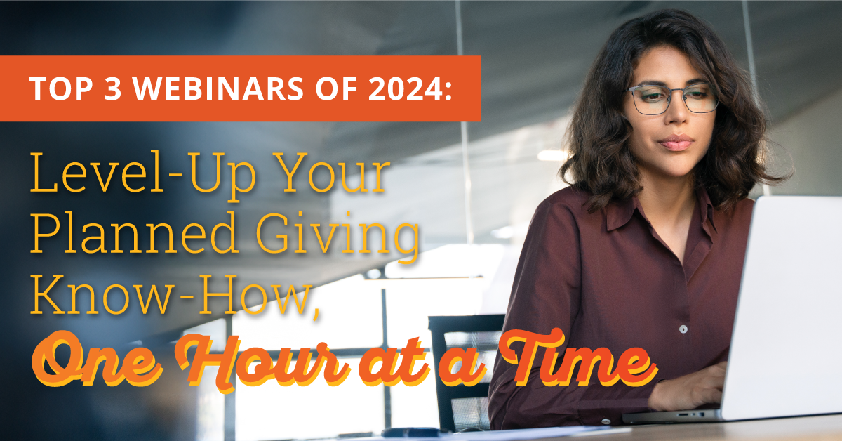 Image of a woman with shoulder length dark brown hair wearing glasses and a brown button down blouse. She is sitting at a desk in an office setting looking at her white laptop. Orange text on the left side of the image says "Top 3 Webinars of 2024: Level Up Your Planned Giving Know-How, One Hour at a Time"